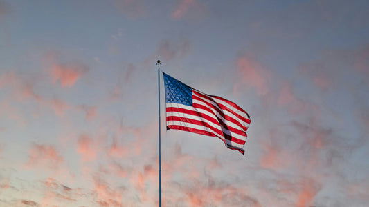 American flag flying above a hockey rink, representing the U.S. prep school hockey environment European players consider on their pathway to North America.