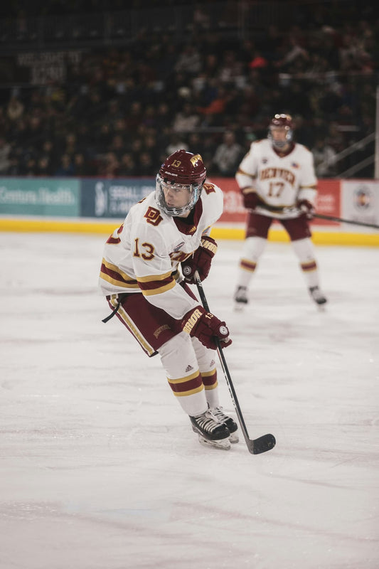 Hockey player receiving individual coaching attention on the ice, illustrating the focused correction private coaching provides.